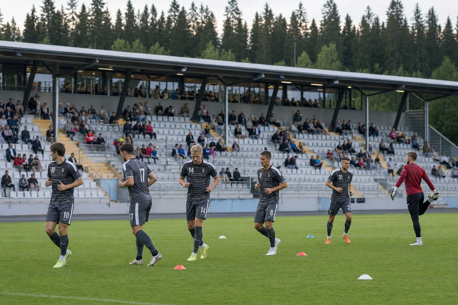 Uppvärmning med passningsövningar framför en gles läktare.